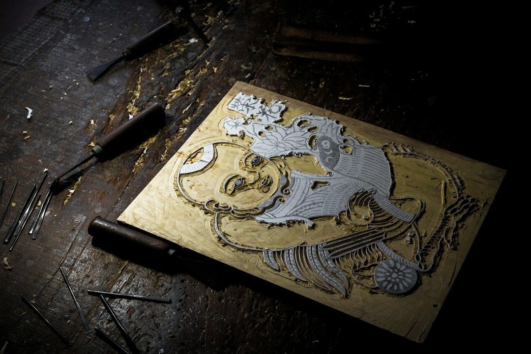 Wood engraving of a fantastical figure surrounded by carving tools