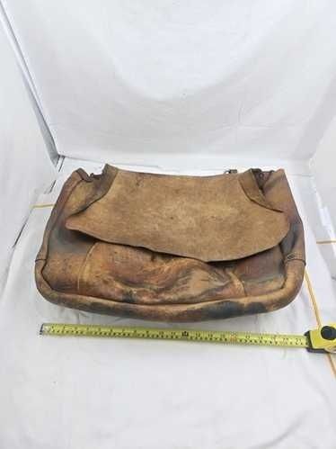 Worn brown leather satchel or mail bag measured with a tape